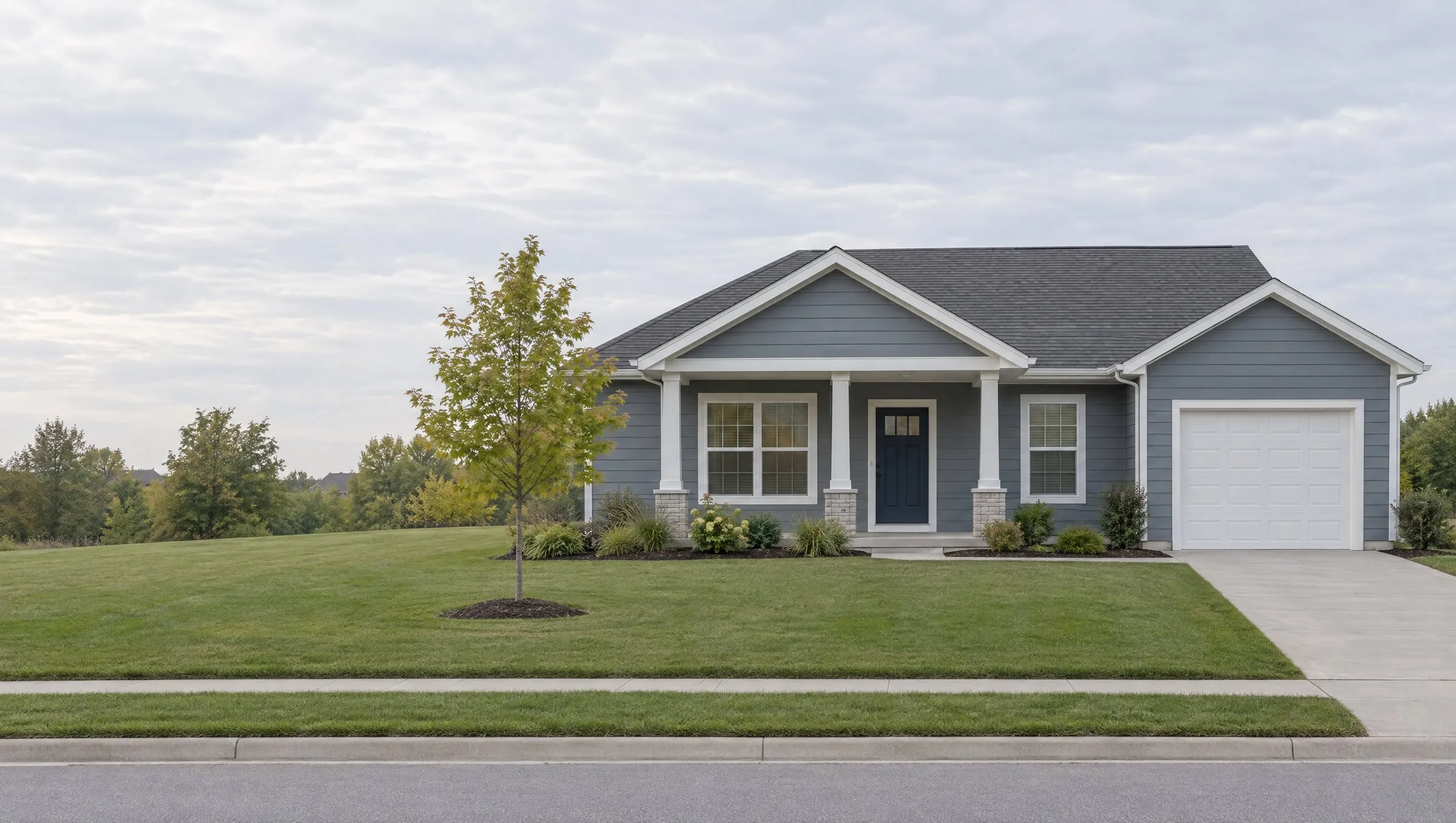 Fictional subject: a one-story gray-blue house with a covered porch and a one-car garage.