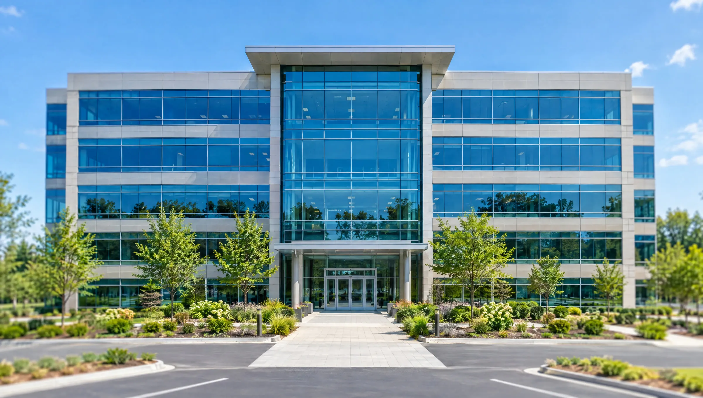 A five-story office building with a blue glass facade and a landscaped entry plaza, with a small star watermark in the lower right corner.